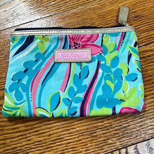 Lilly Pulitzer fabric makeup bag with gold detailing.  Appropriate size 7”x5”.